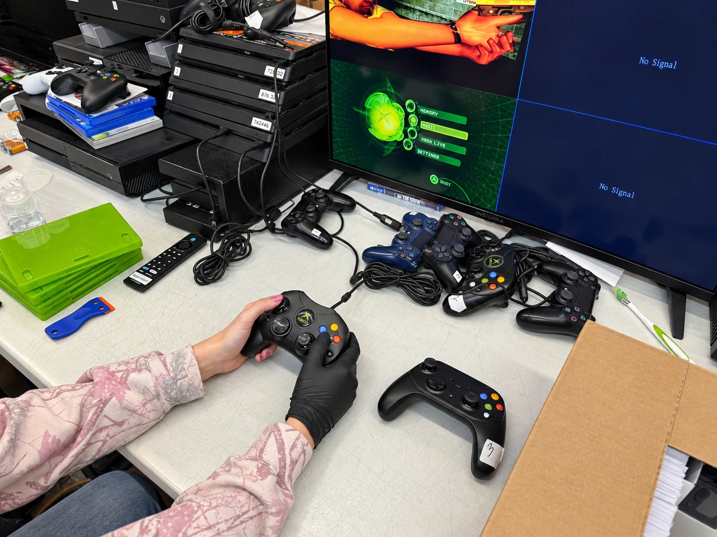Testing controllers on real consoles before anything is resold.
