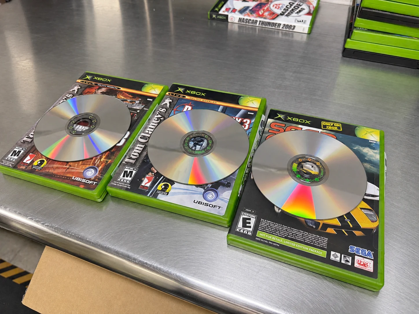 Three original Xbox discs fresh out of our disc refurbishing machines.